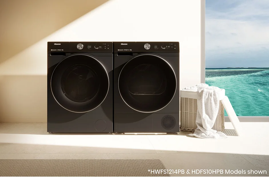 Hisense black washer and dryer set (model HWFS1214PB & HDFS10HPB) in a modern laundry room with ocean view - stylish, energy-efficient laundry appliances for New Zealand homes.