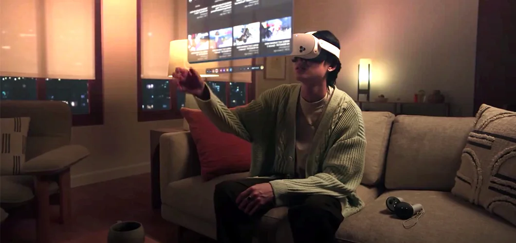 Man sitting on a couch wearing Meta Quest 3 headset