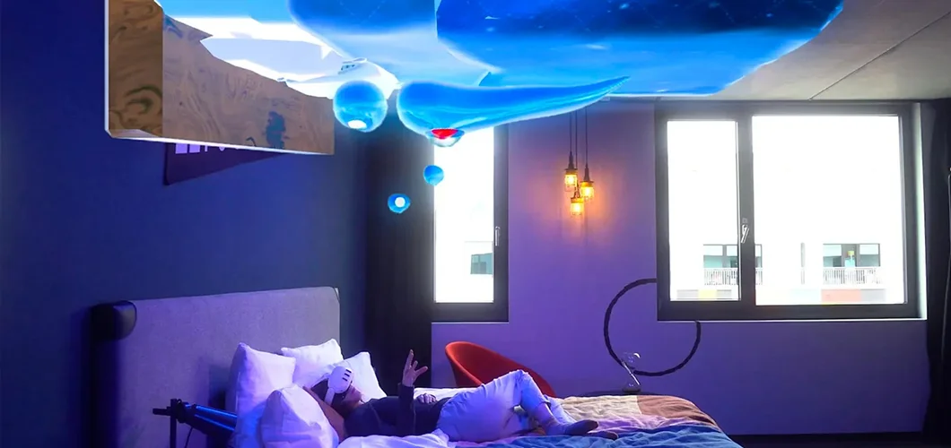 Woman lying in bed wearing a Meta Quest 3 headset with surreal blue floating objects above her