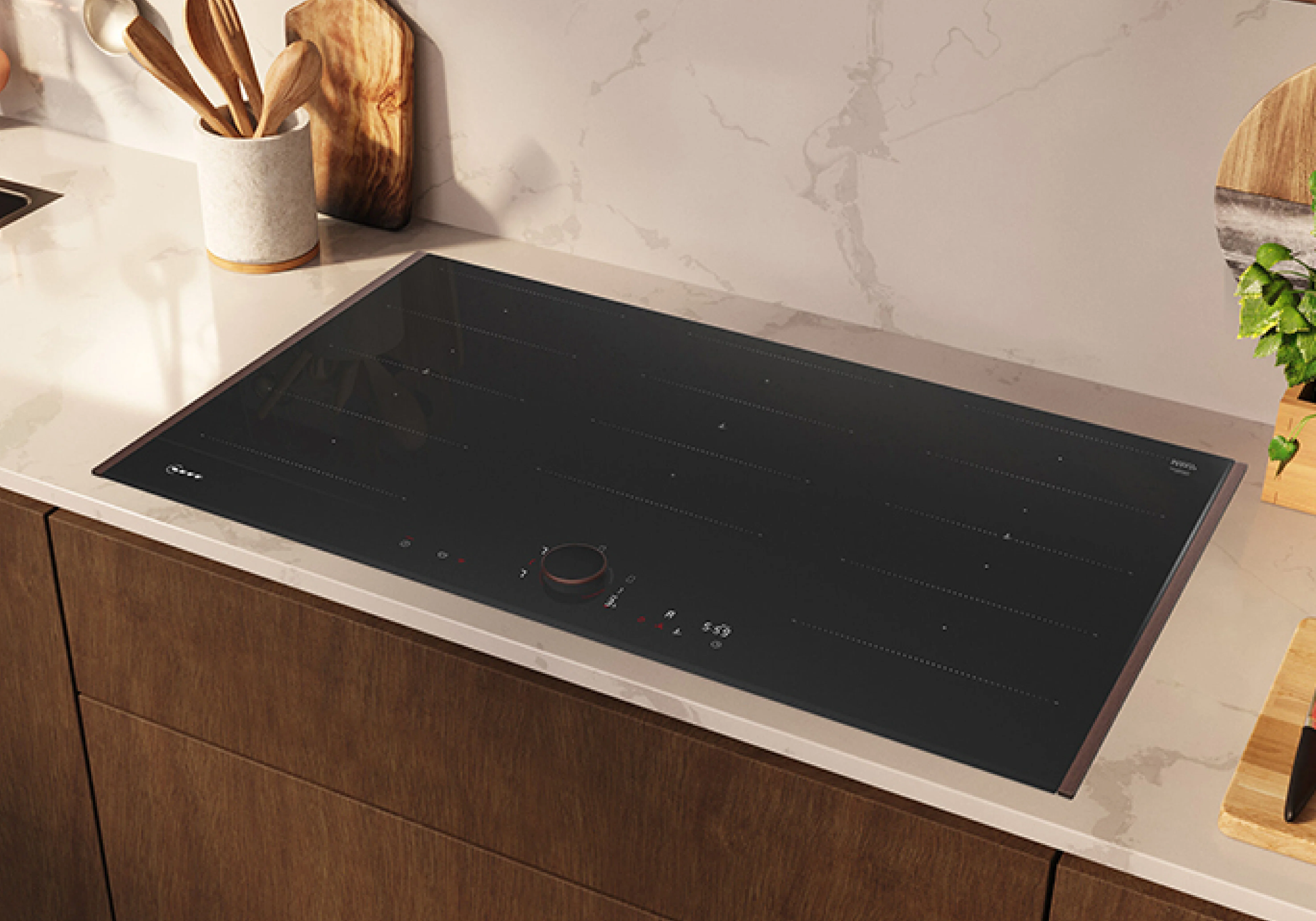Modern kitchen with a person using a wall-mounted rangehood above an induction cooktop, which has a steaming pot on it; various kitchen items and plants are arranged on the countertop.