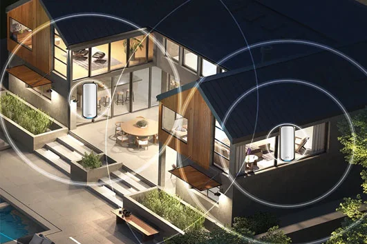 A modern home with graphics of the Orbi WiFi 7 mesh system's coverage area overlayed, showing a seamless connection throughout the home.