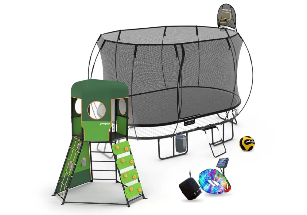 Children's playset featuring a trampoline with safety net and basketball hoop, a green playhouse with climbing features, and assorted outdoor toys.