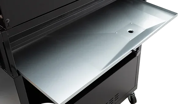 Close-up of a Gasmate Quasar BBQ's stainless steel drip tray extended from a black wheeled cabinet.