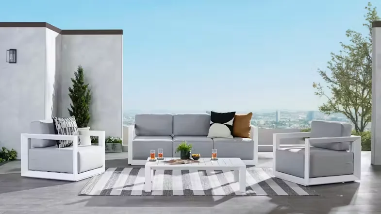 Shore 4 Piece Outdoor Lounge Suite on a modern balcony overlooking a city