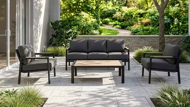 Malta 4 Piece Outdoor Lounge Suite on a patio with a lush garden