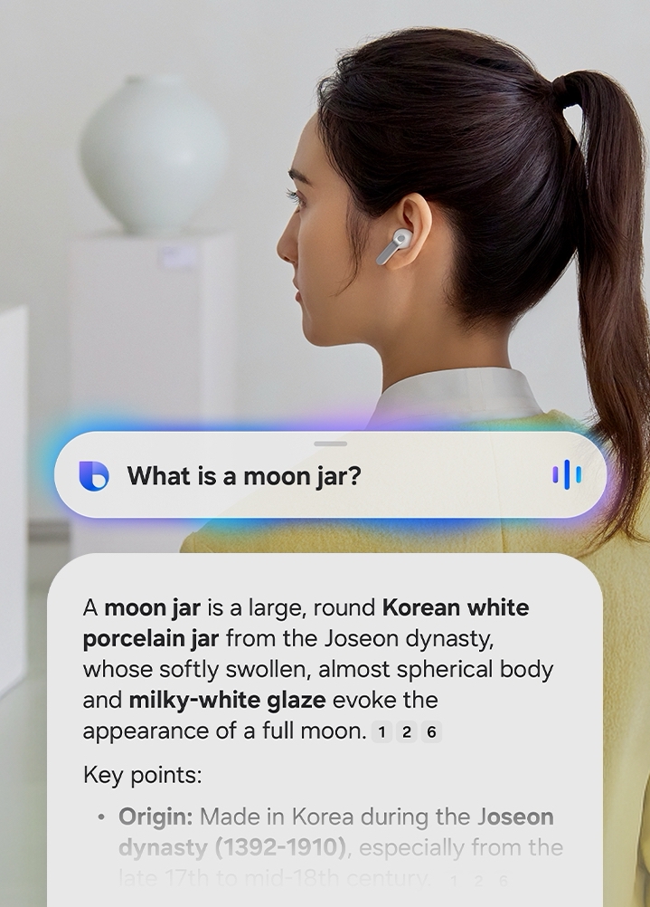 A rearview shot of a woman using a single, white Galaxy Buds4 Pro. Nearby, a text bubble asking AI, 'What is a moon jar?' Below the text bubble is a separate bubble with the response 'A moon jar is a large, round Korean white porcelain jar from the Joseon dynasty, whose softly swollen, almost spherical body and milky-white glaze evoke the appearance of a full moon.' Below is a list of the key points of a moon jar.