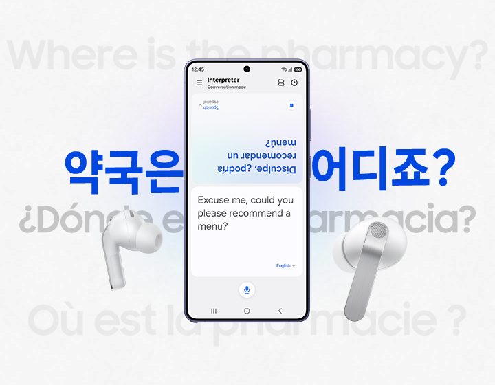 A Galaxy smartphone in between a pair of white, Galaxy Buds4 Pro. In the background is the phrase 'Where is the pharmacy?' in multiple languages. The smartphone shows the Interpreter screen open with the Spanish translation on the top half of the screen, and the English version on the bottom half of the screen.